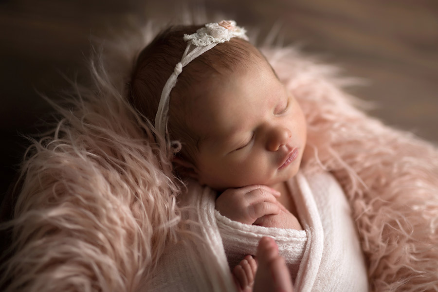 a photo of a newborn wrapped in soft sheets