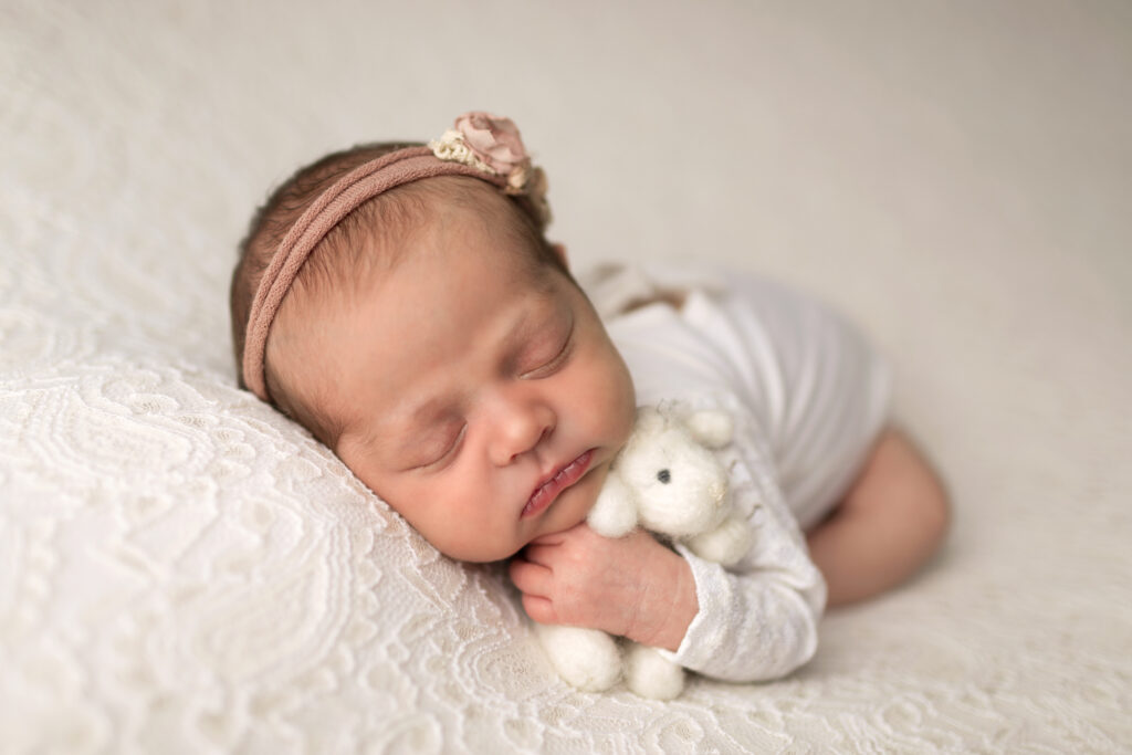 a newborn with a soft plushy toy